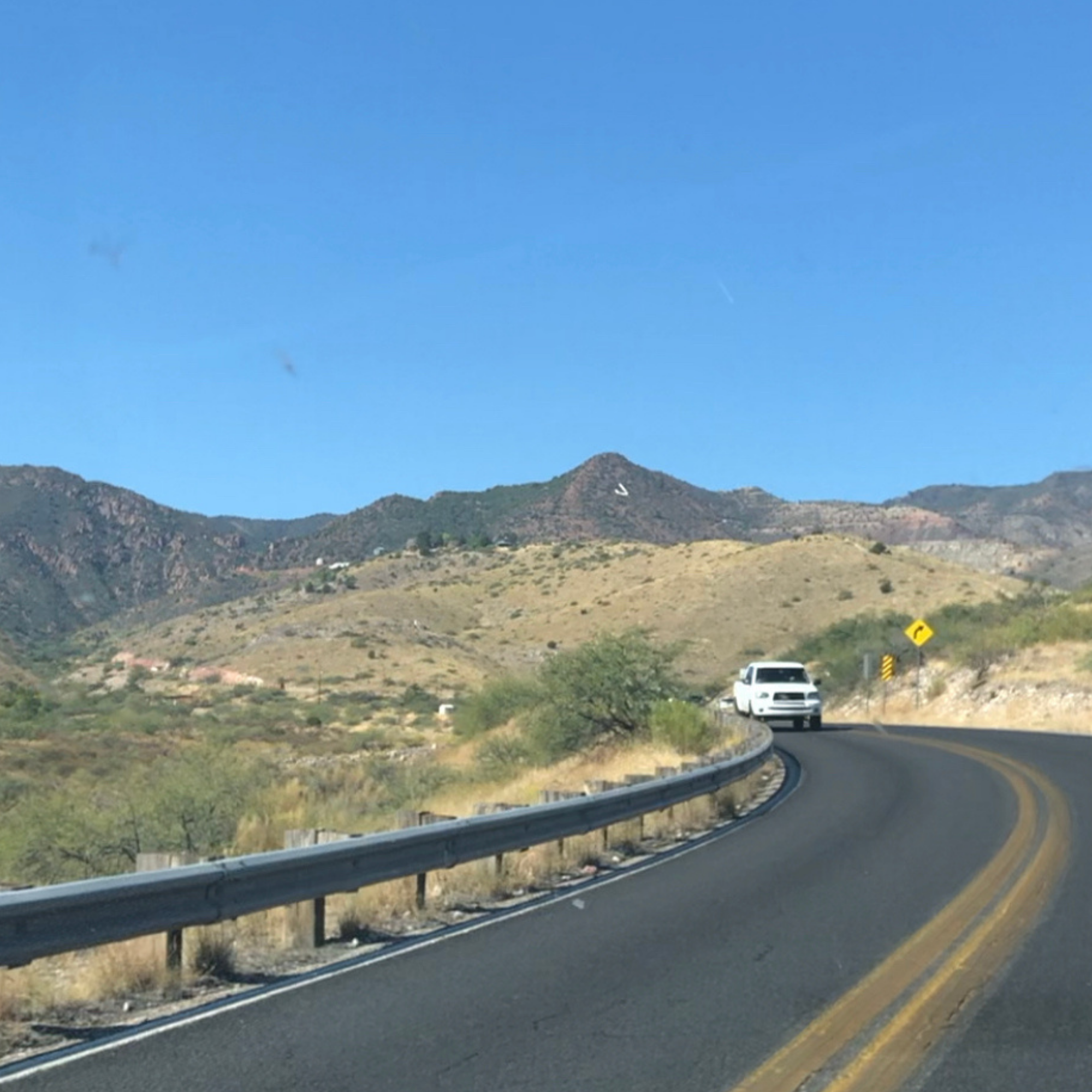 driving on road towards jerome arizona with the J on the side of the mountain