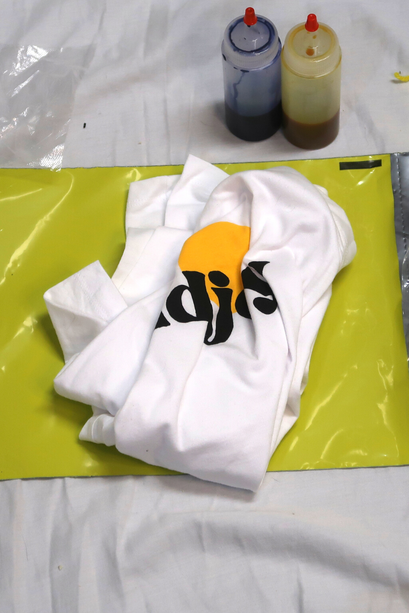 Lay plastic underneath the place you'd like to tie-dye