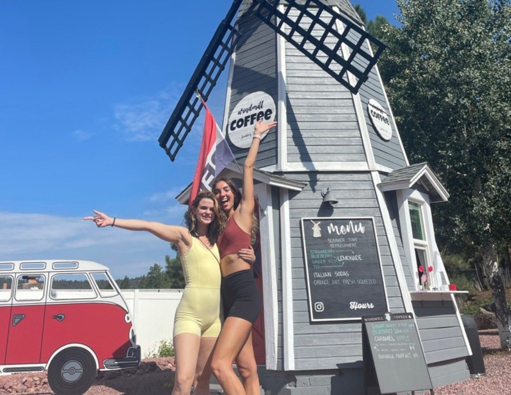 two tall girls posing infront of a windmill inspired coffee shop in Strawberry, Arizona