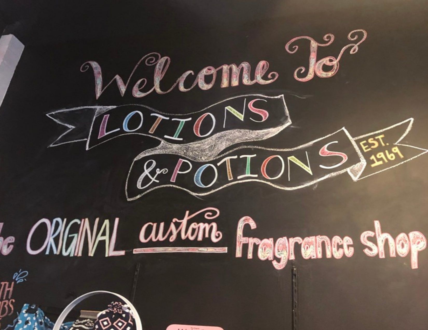 Calkboard sign saying Welcome to Lotions and Potions the Original Custom Fragrance Shop in Tempe Arizona