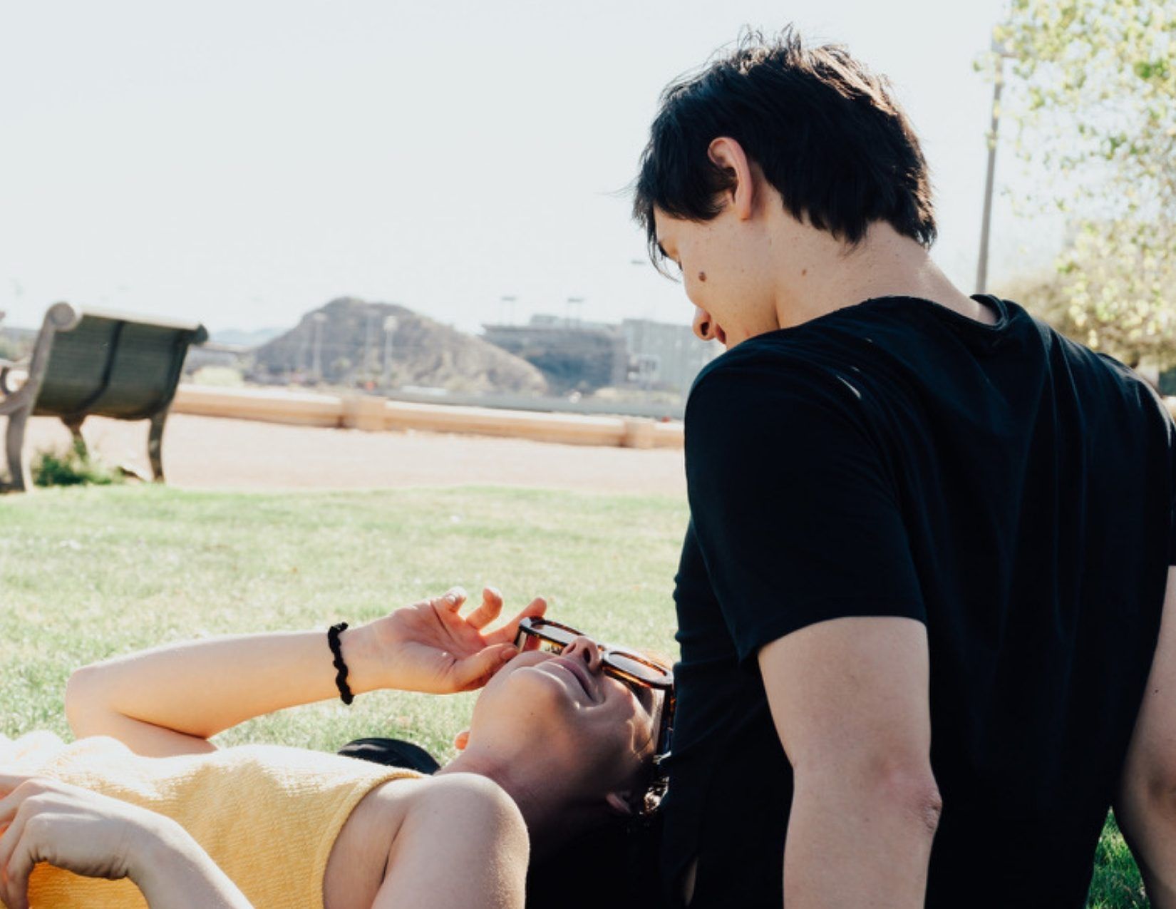Young man and Girl having a picnic in the grass at Tempe Town Lake in Tempe Arizona