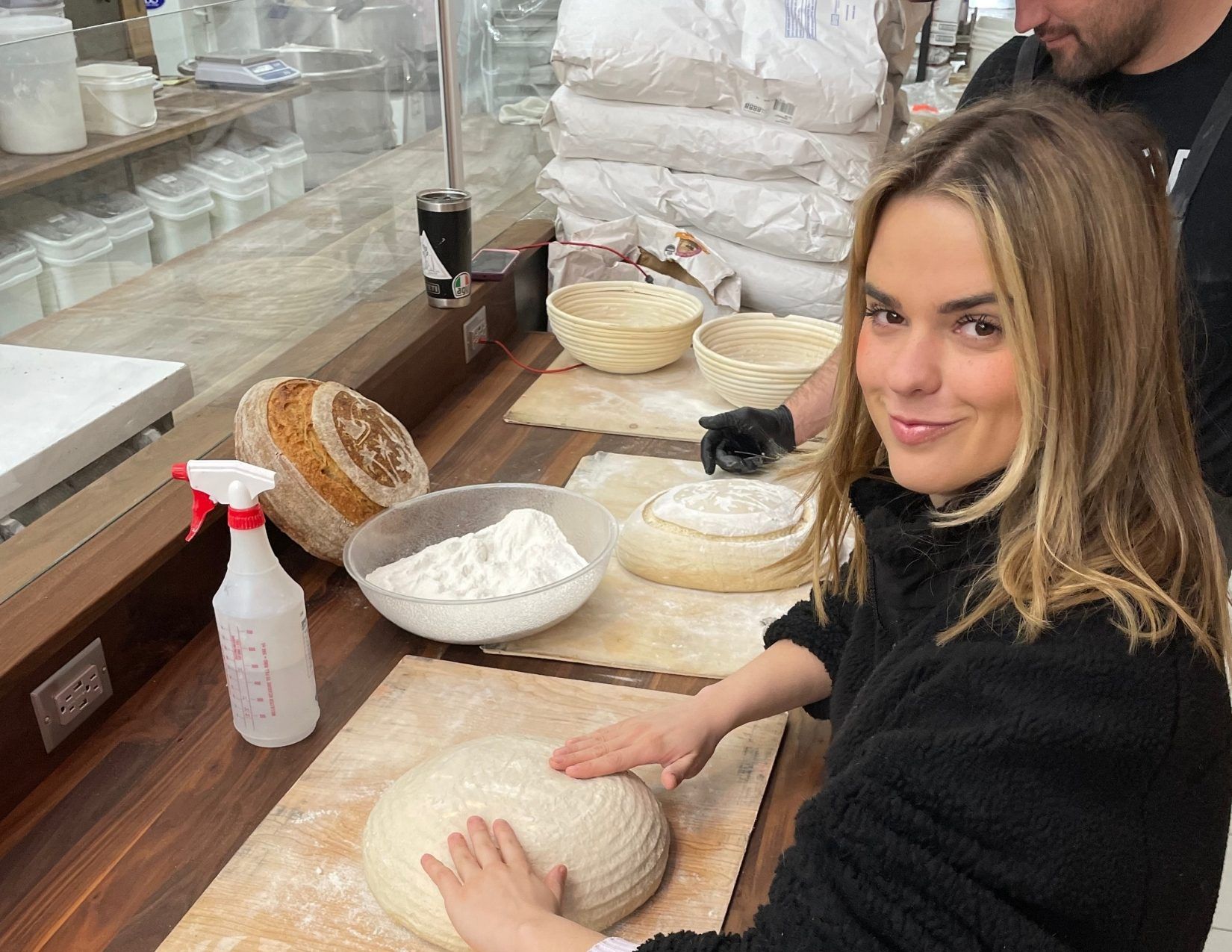 an instructor teaching a girl how to make dough and proof bread in Mesa Arizona