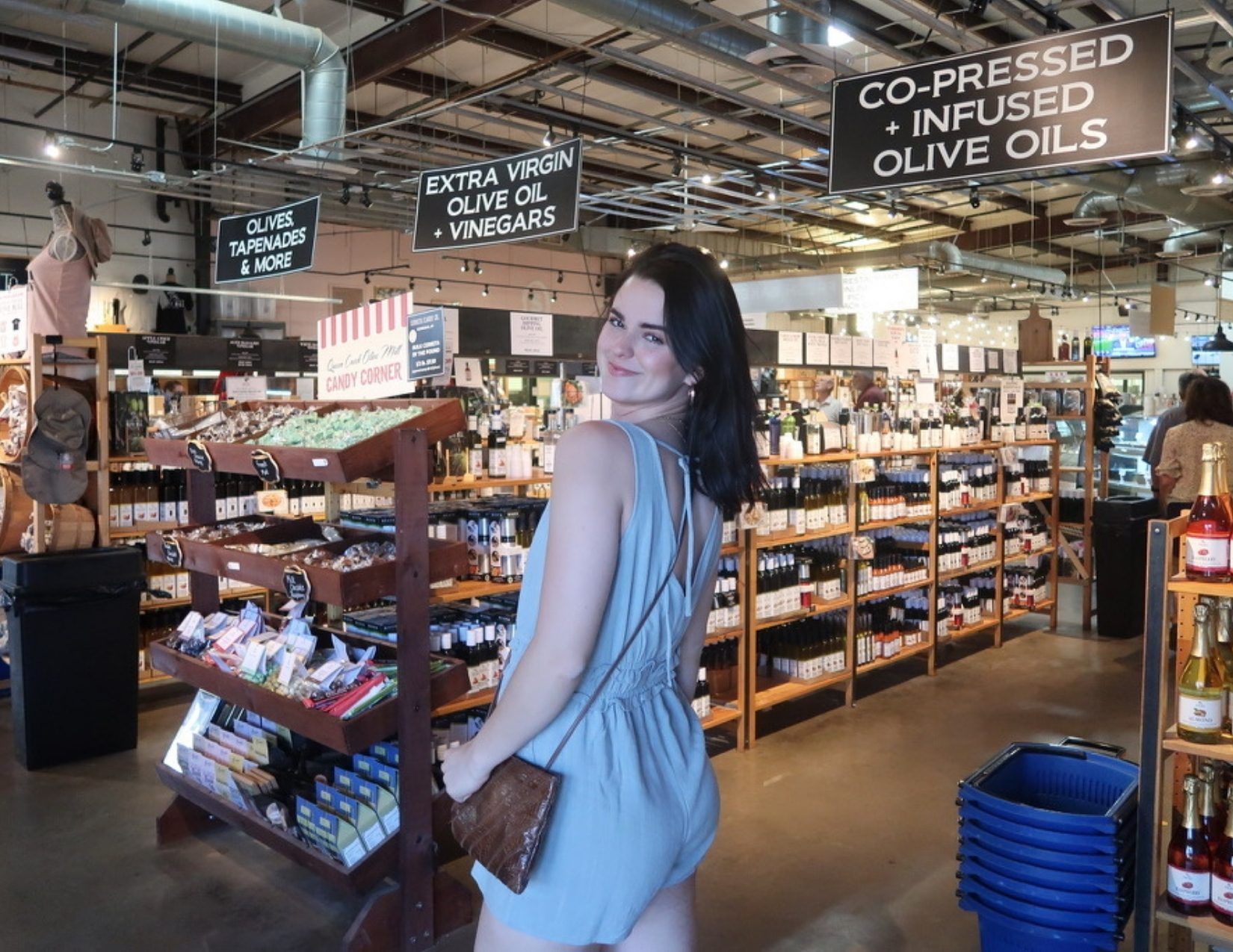 Young Girl standing by shelves of olive oil at Queen Creek Olive Mill in Mesa Arizona