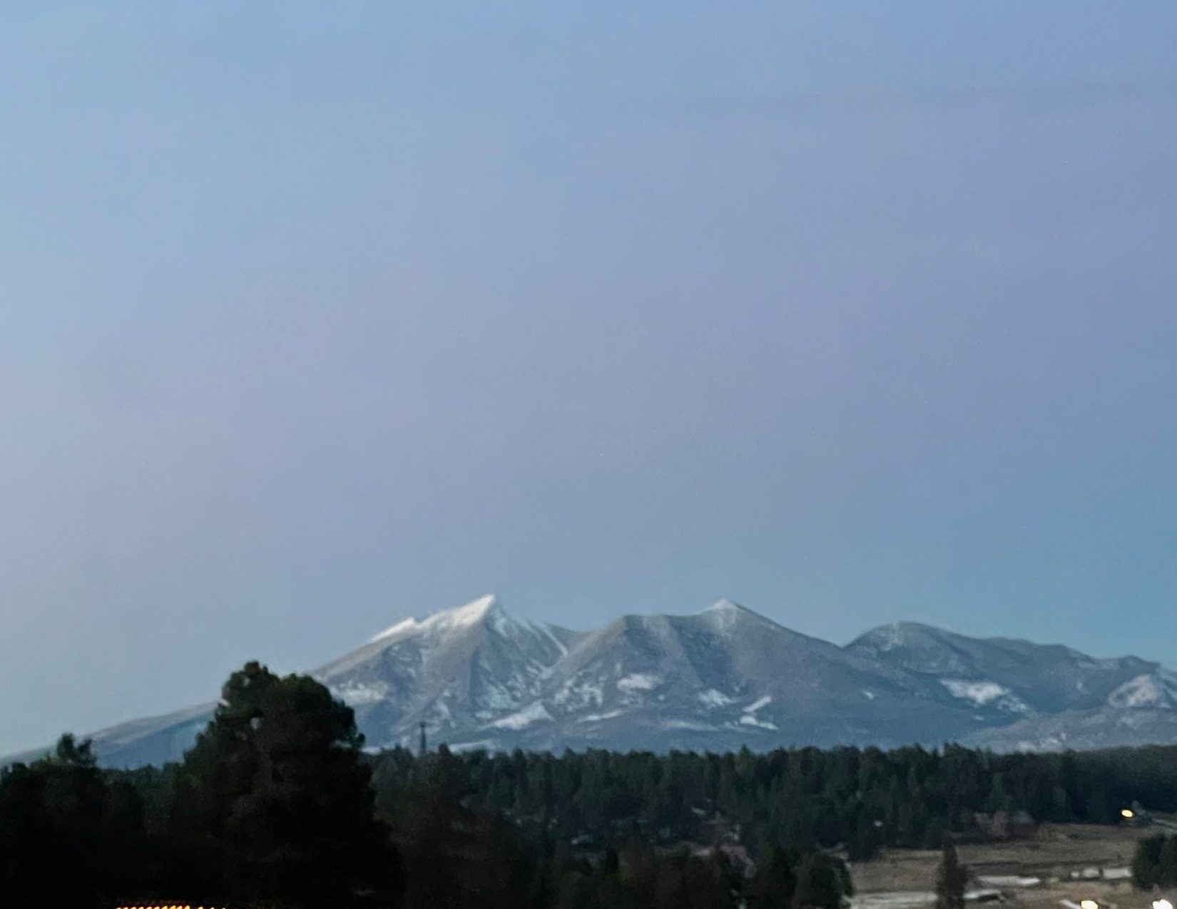 View of snowcapped mountains as you enter Flagstaff, Arizona