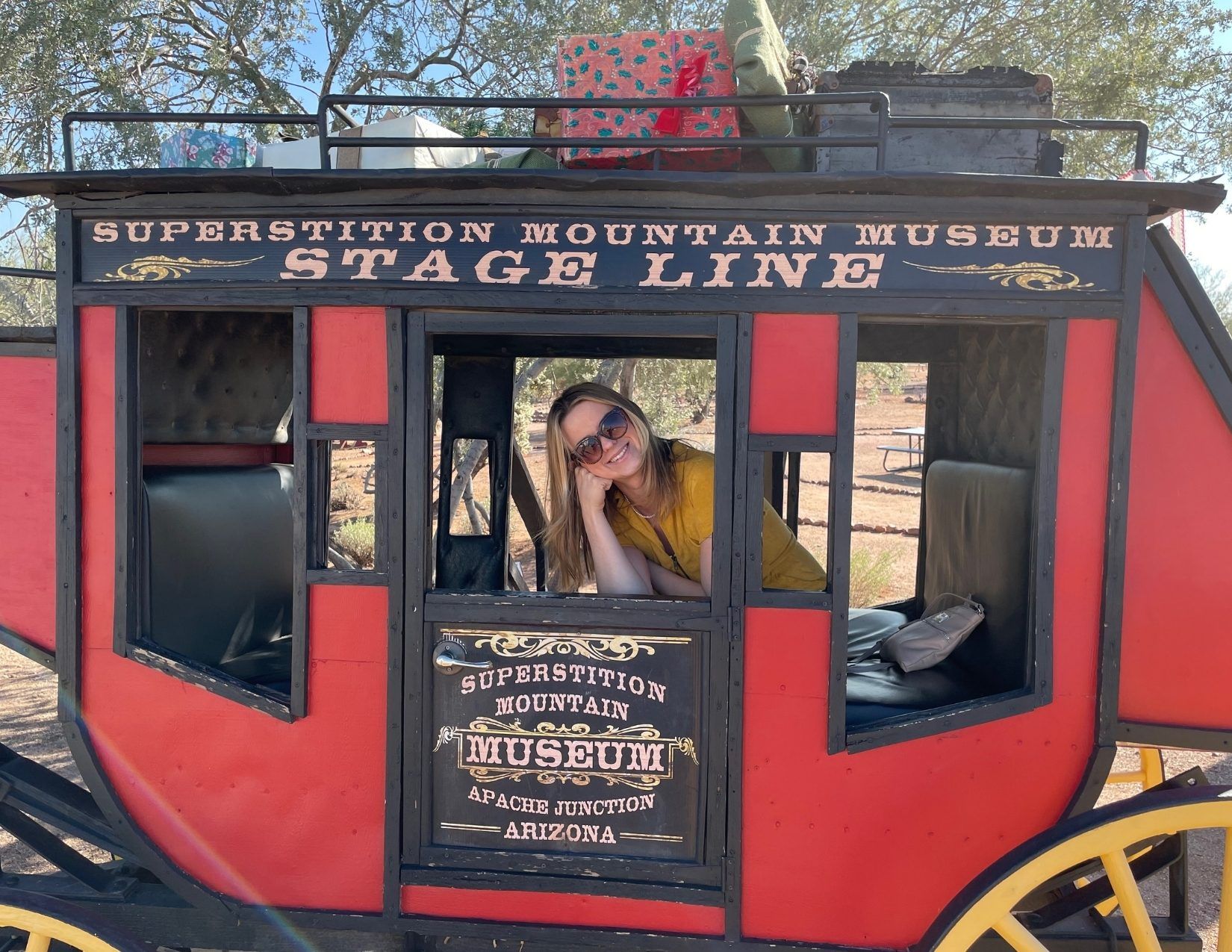 a girl posing in a stagecoach in Mesa, Arizona