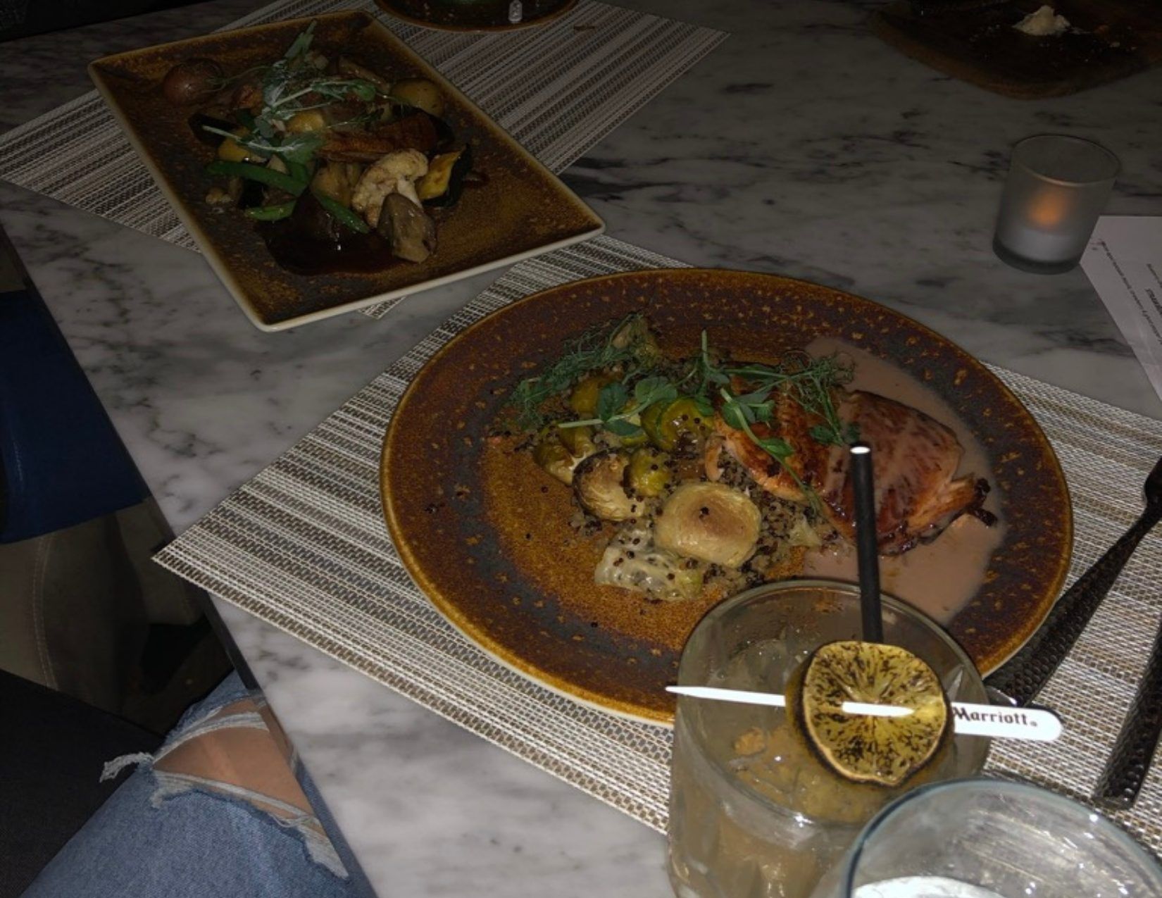 Two dinner plates and a drink glass showing delicious food at Top of the Rock at Phoenix Marriott Resort Tempe Arizona