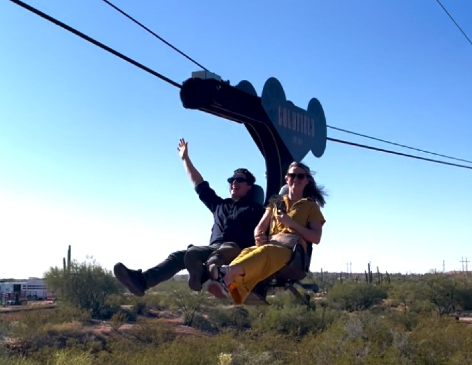 a young couple riding the zip-line in Goldfield Ghost Town, Mesa Arizona