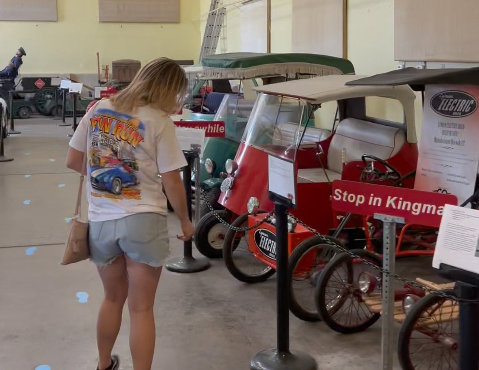 Young Girl looking at old Electric Vehicles on display at the Electric Vehicle Museum in Kingman Arizona