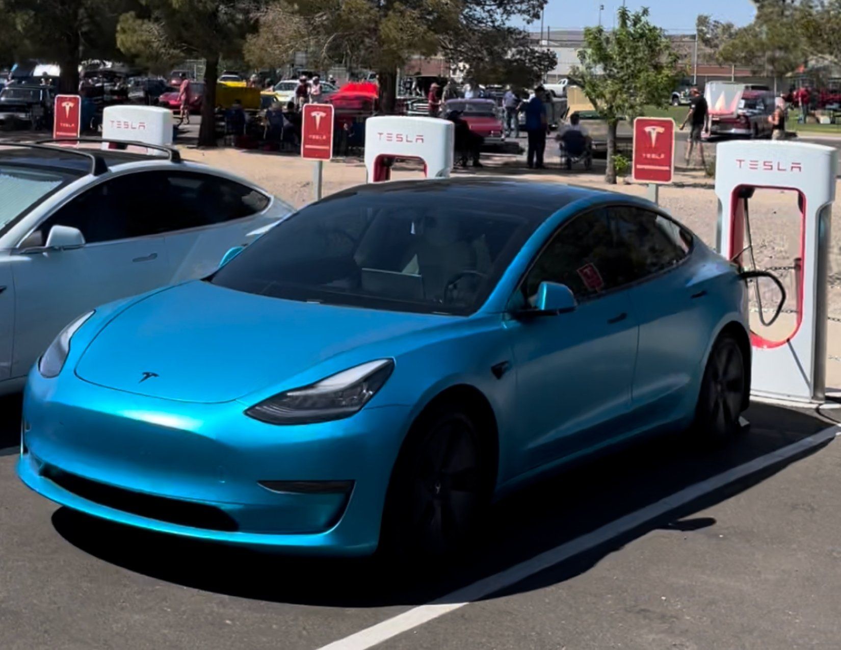 Blue Tesla Electric Car charging at the Tesla EV charging station in Kingman Arizona