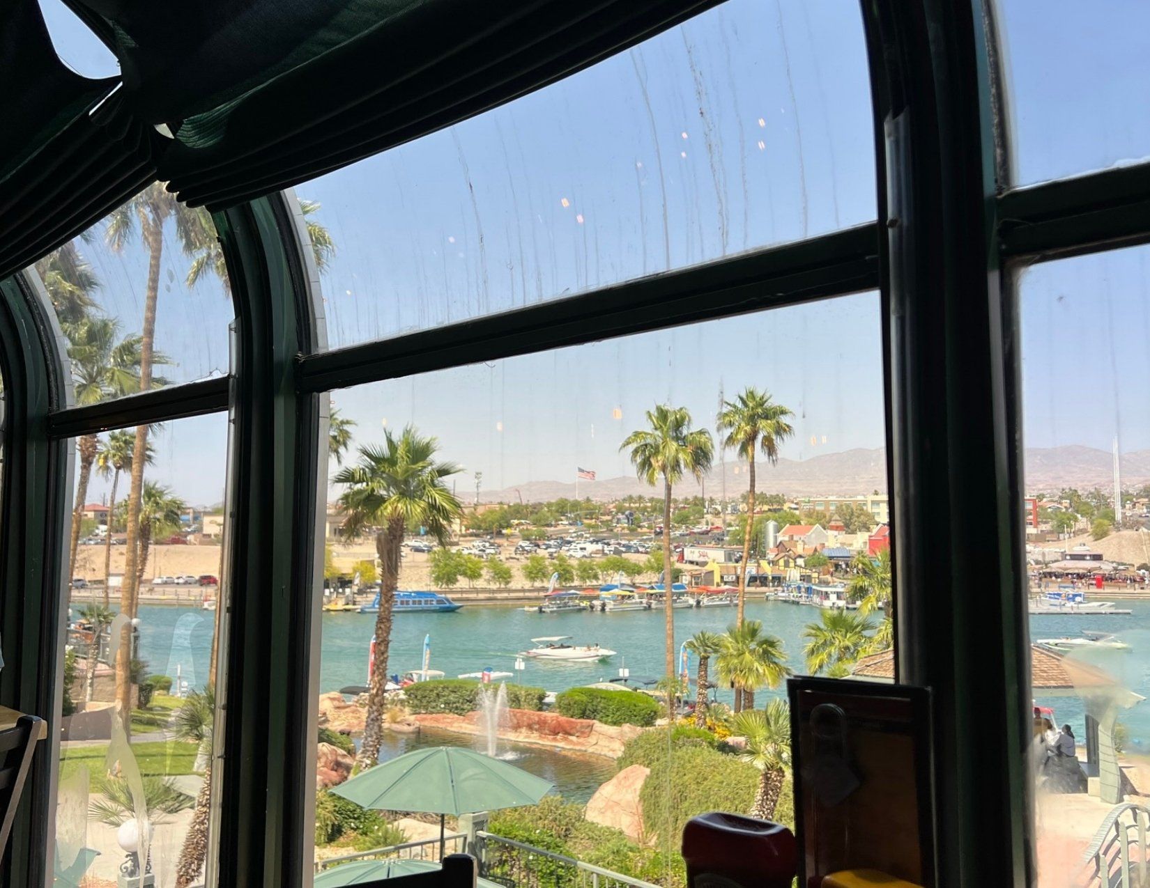 view of Lake Havasu from a brewery, blue water, palm trees, marina, beachy feel