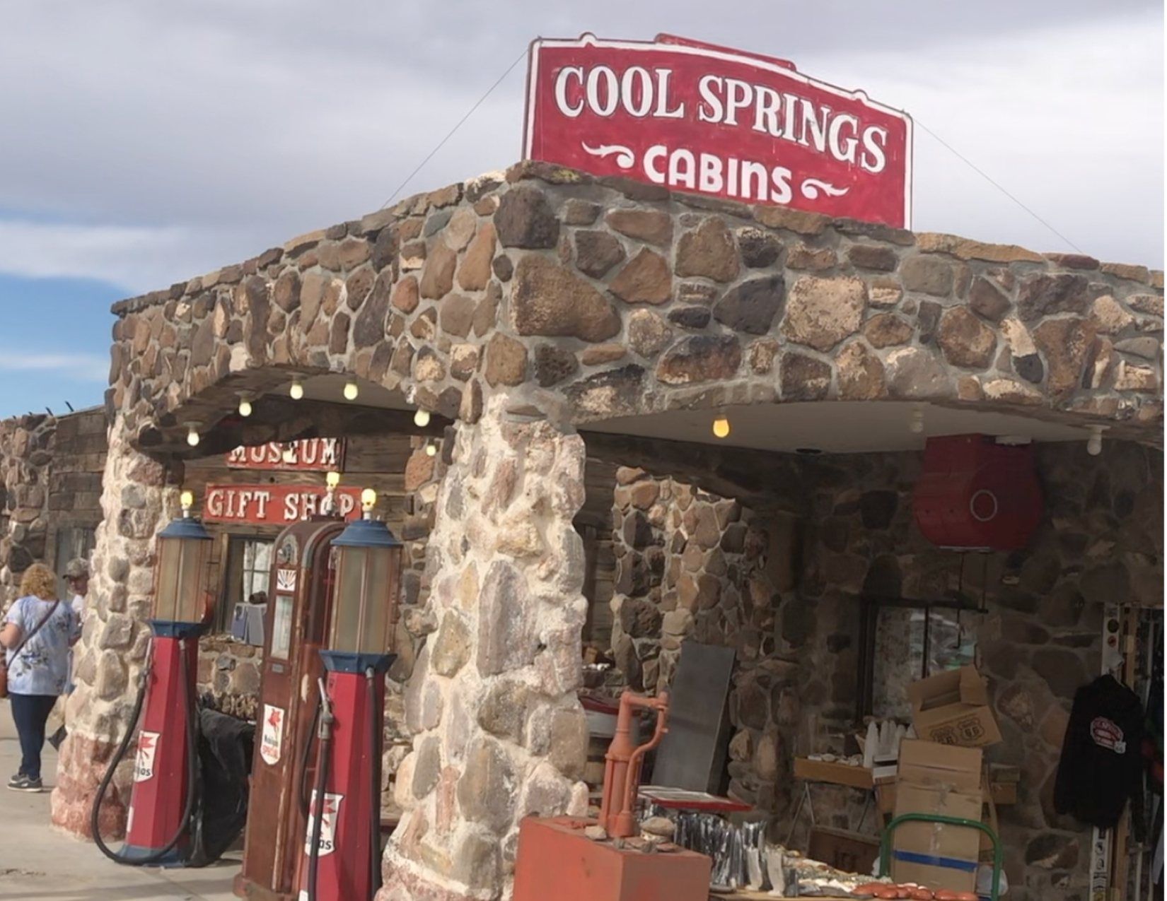Stone Building with Red sign on top showing Cool Springs Cabins at the Cool Springs Station in Arizona