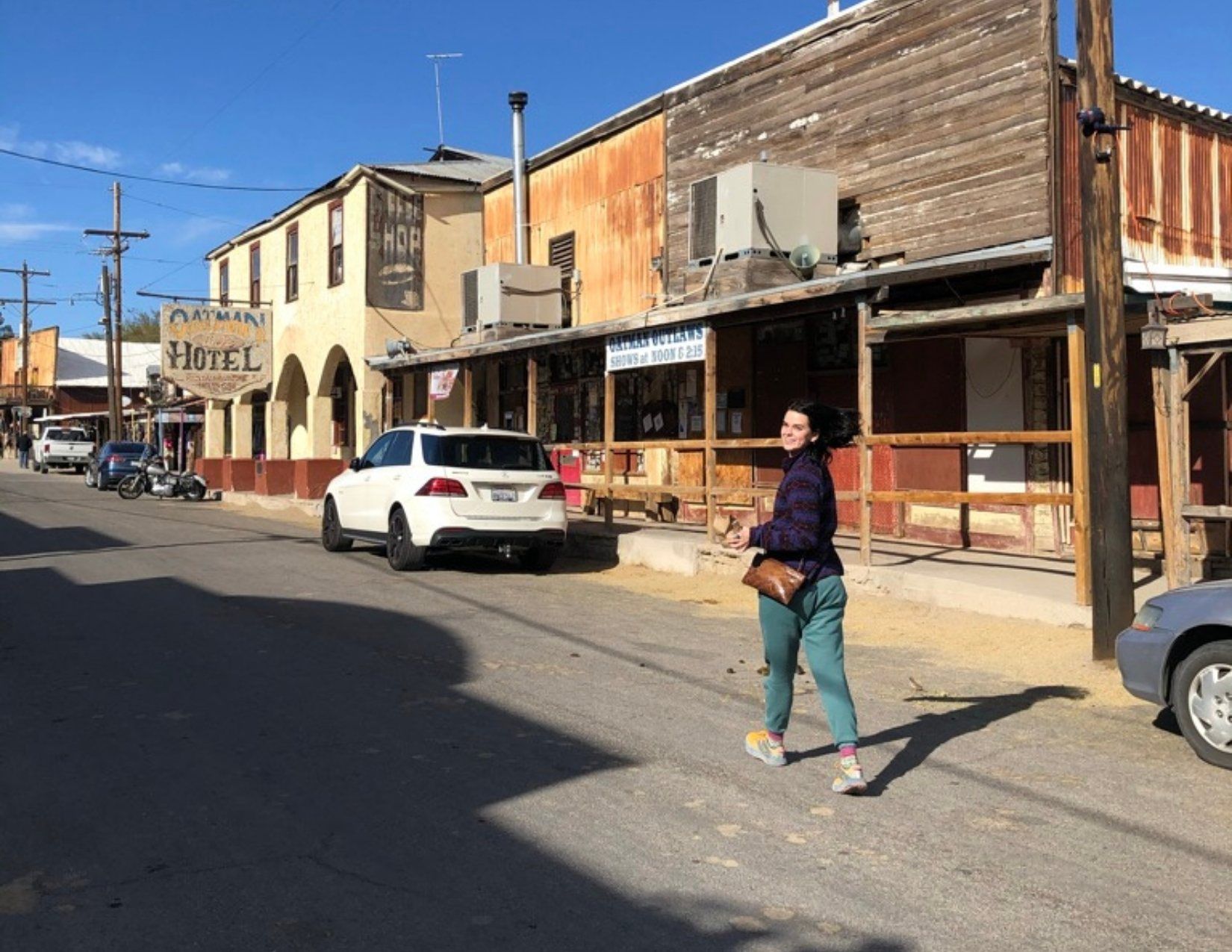 Young girl walking on dirt road to Oatman Hotel in Oatman Arizona