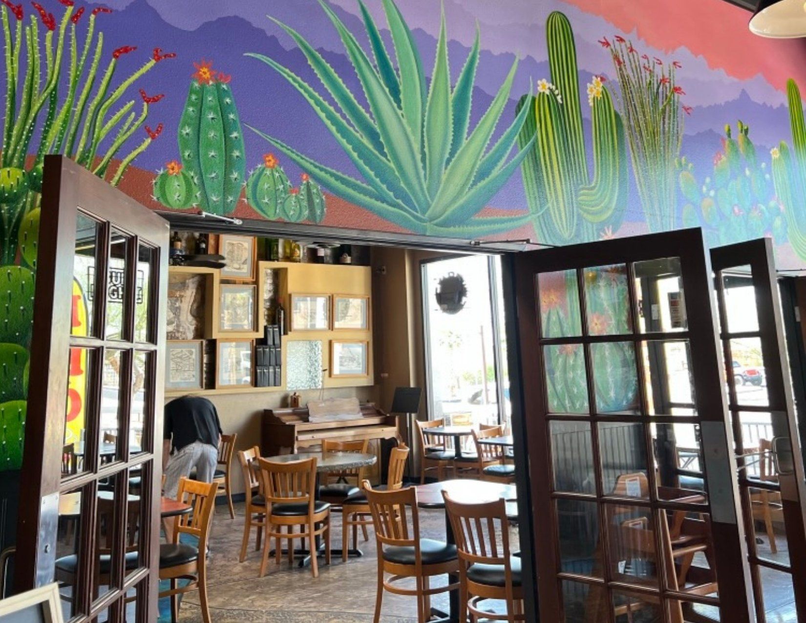 Inside seating at the Kitchen Art Work Space with a desert themed mural