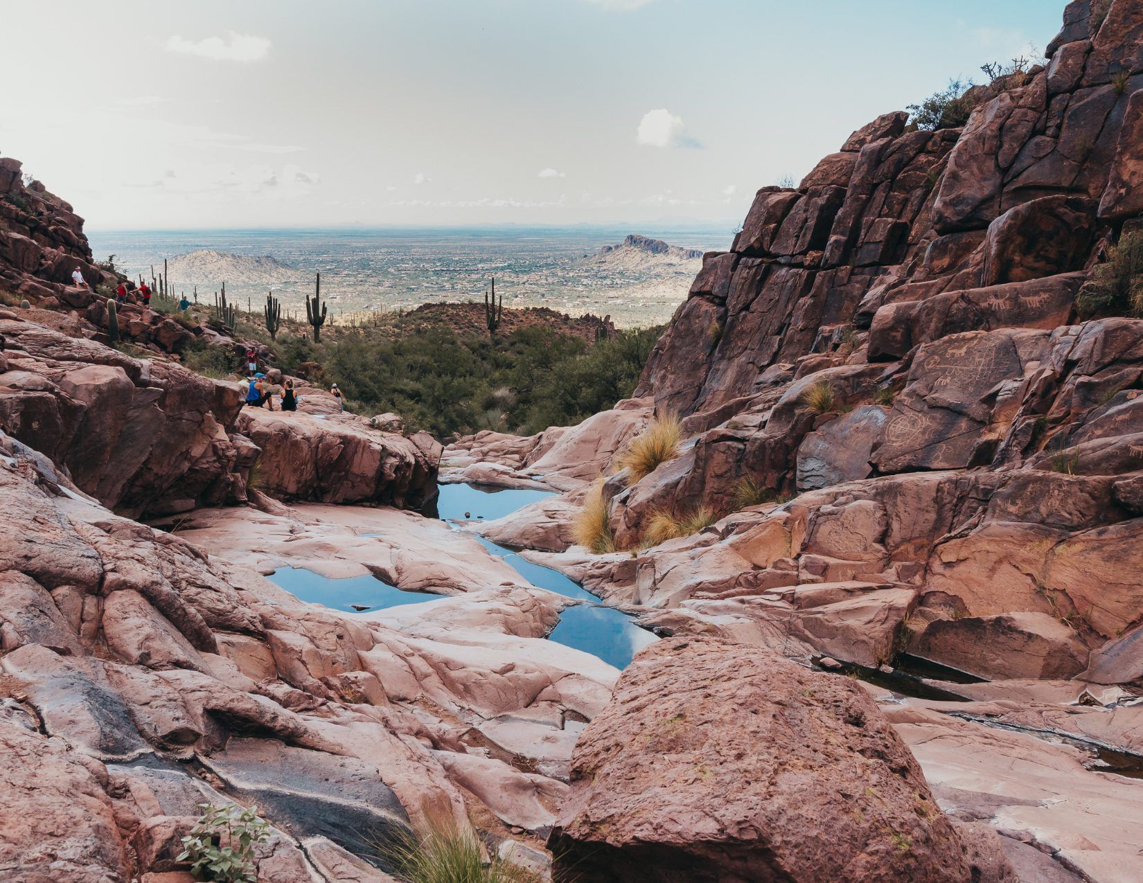 Hikers sitting on Red Rock formations on the Hieroglyphic Trail in Arizona
