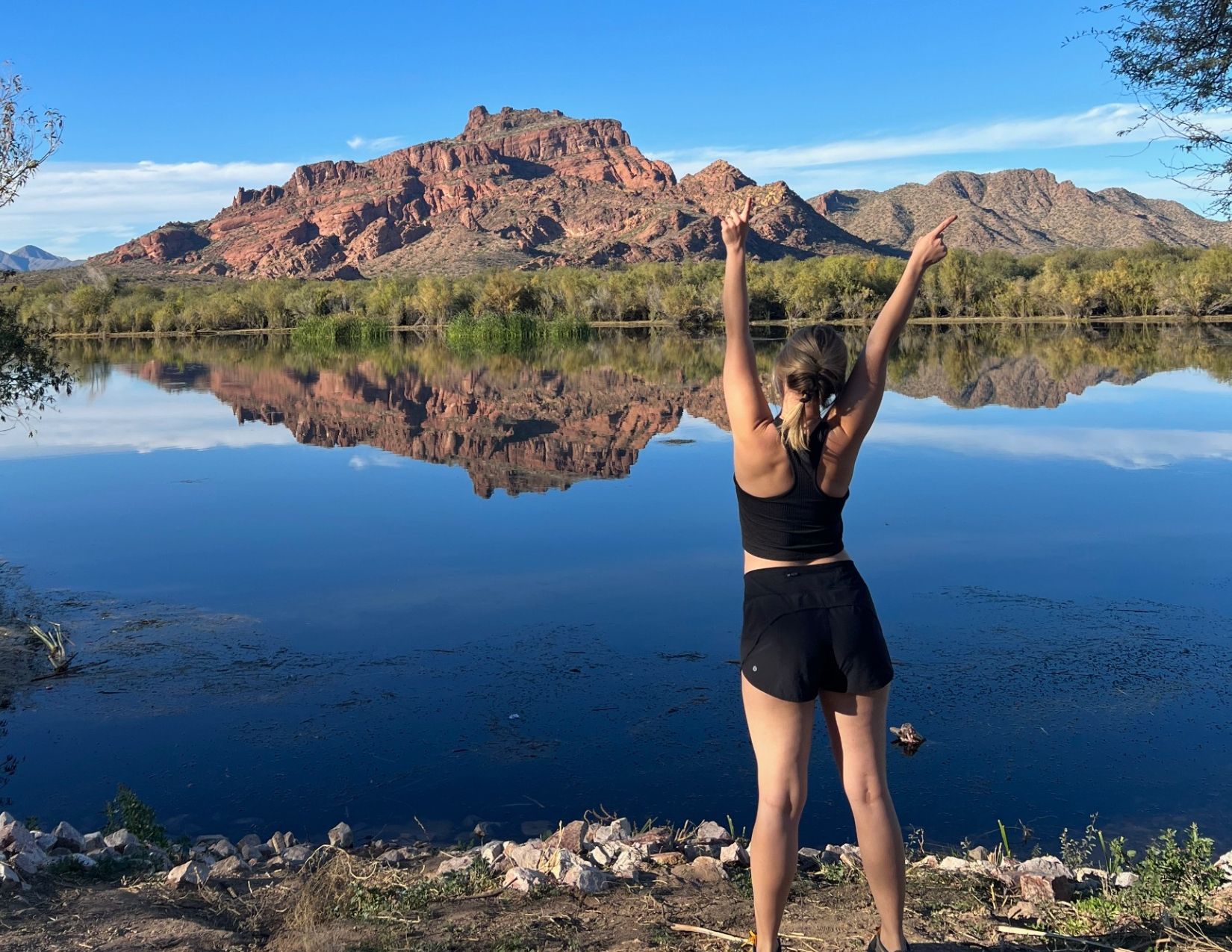 Girl standing in front of gorgeous blue water at the Salt River in Mesa Arizona