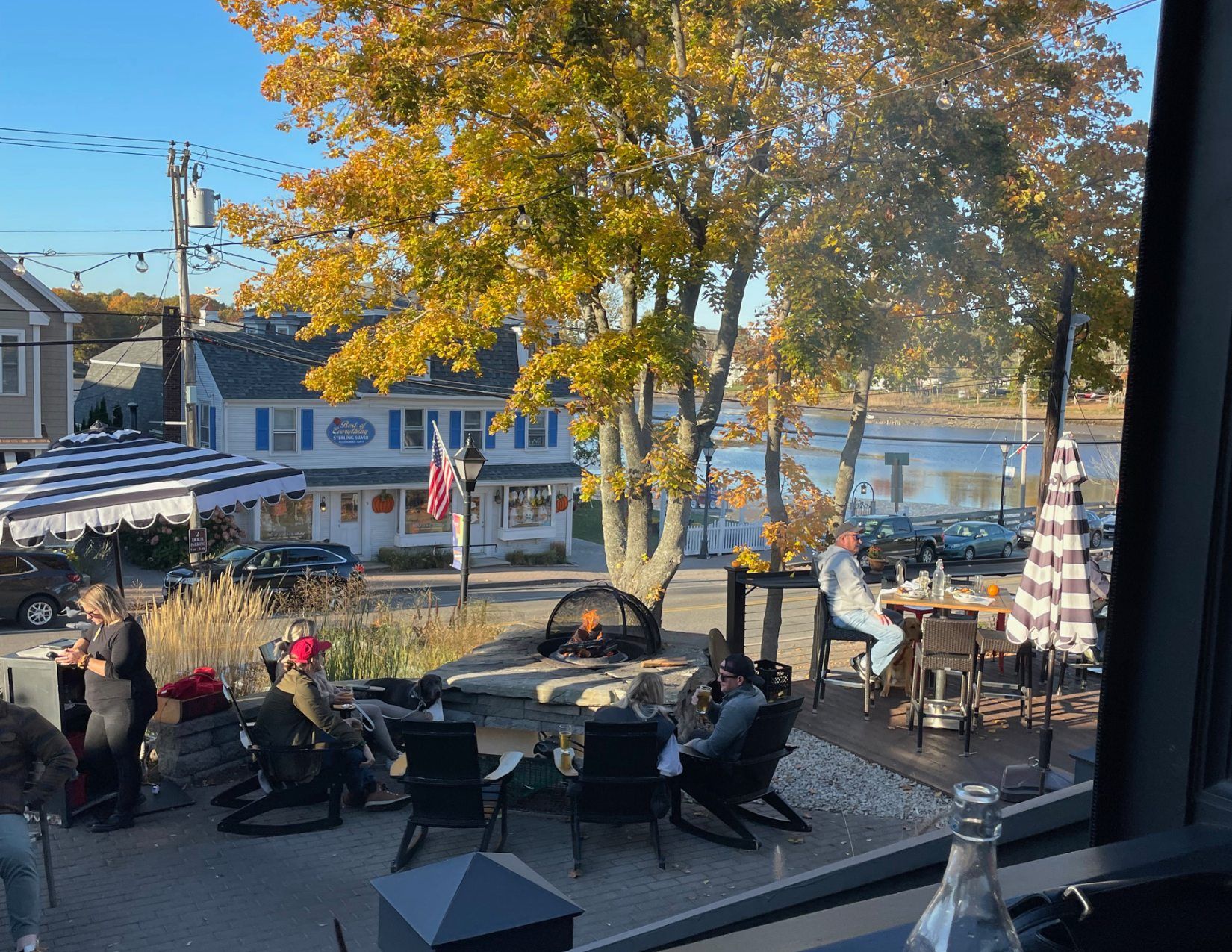 An outdoor patio with a large fire pit at a brewery in the town of Kennebunk, Maine