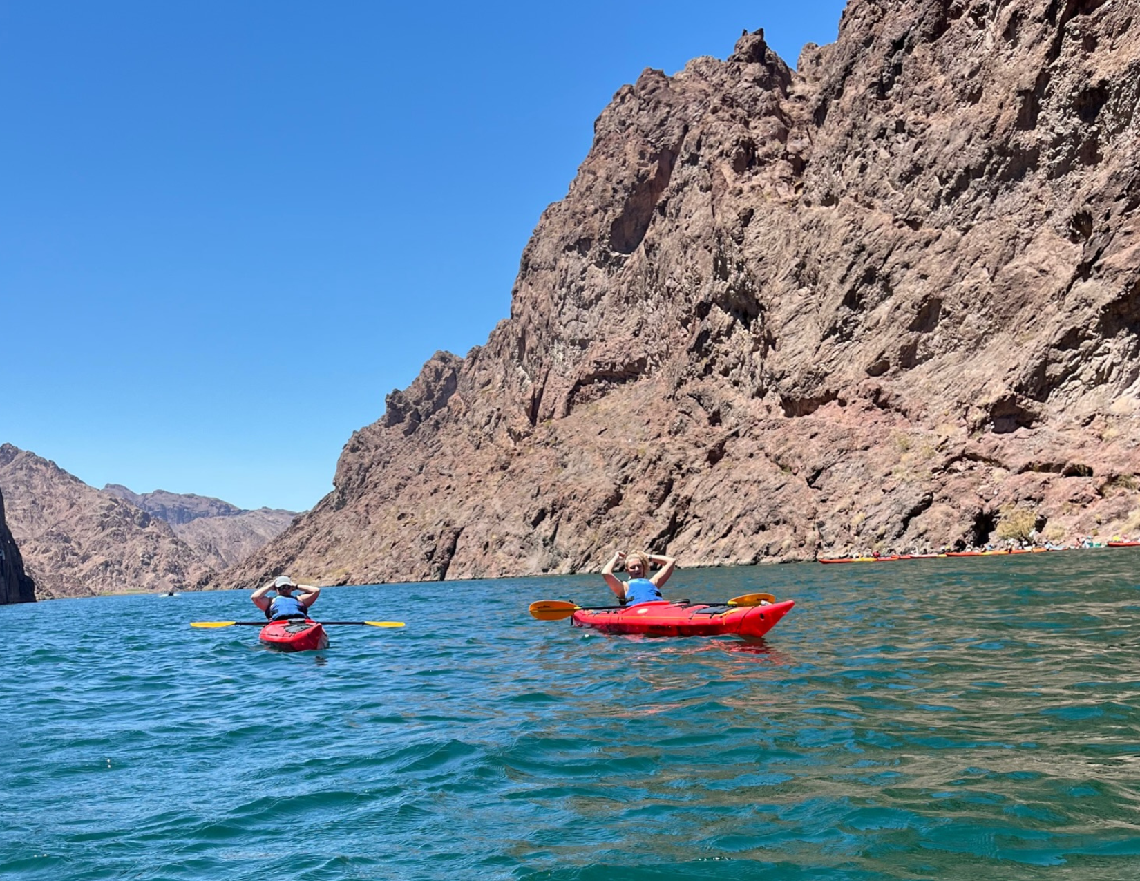 two kayakers enjoying the clear turquoise water at Emerald Cove on the Colorado River near Las Vegas, Nevada