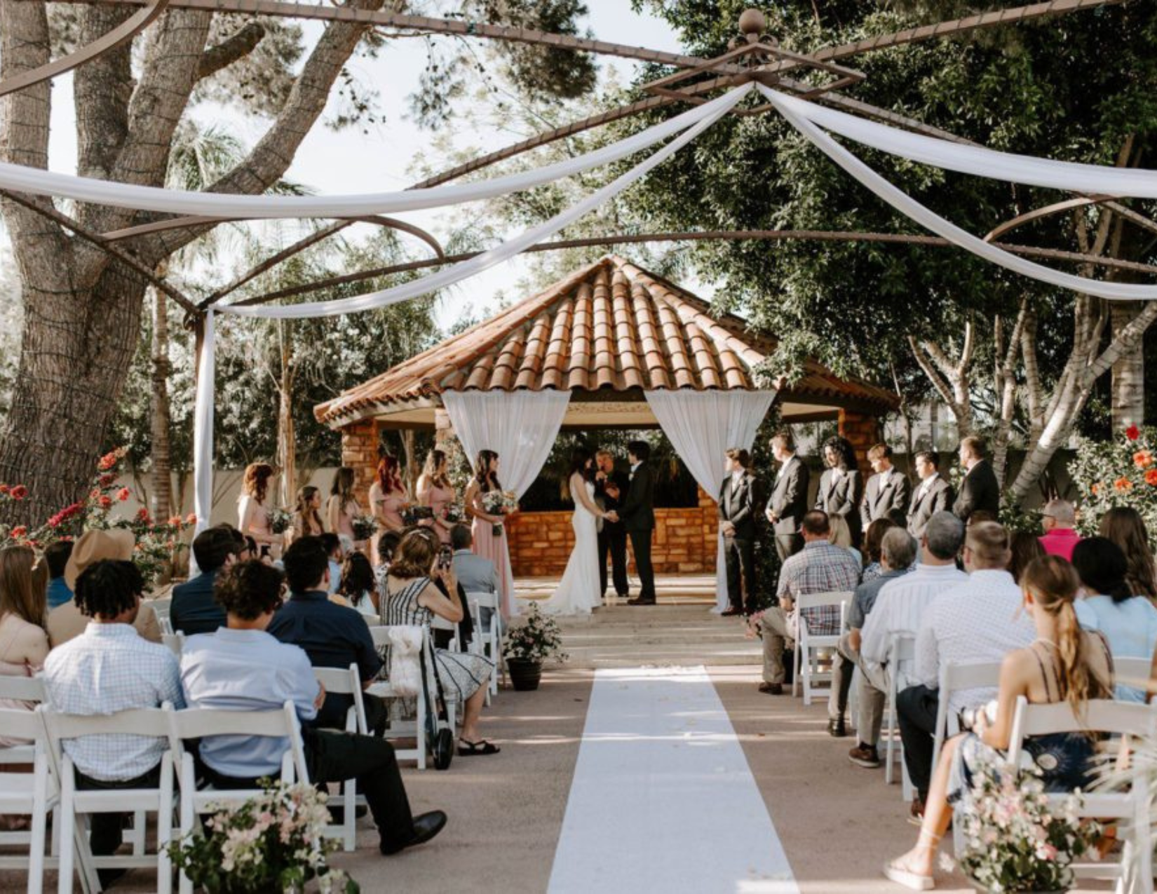 A couple exchanging their wedding vows in front of family at a dreamy outdoor wedding in Chandler, Arizona