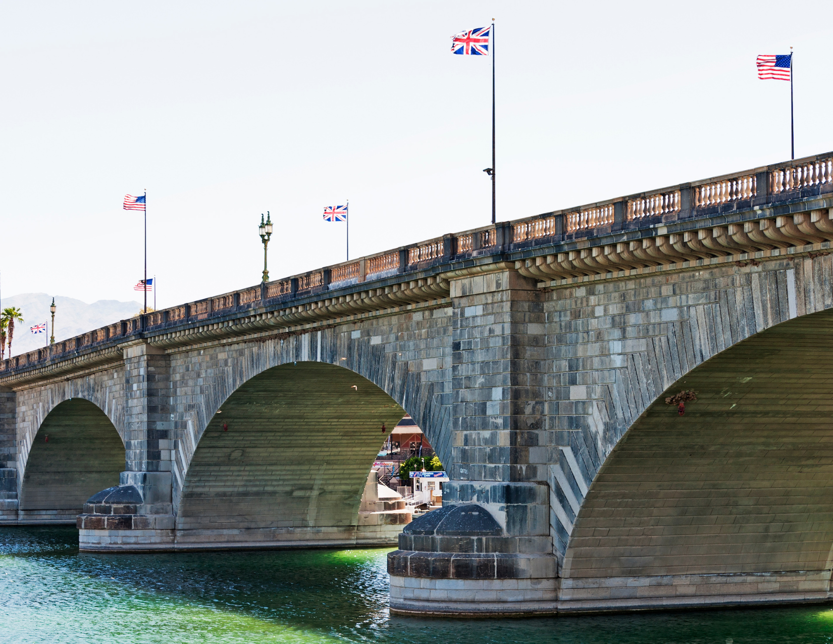 Grand stone bridge over clear water in Lake Havasu City