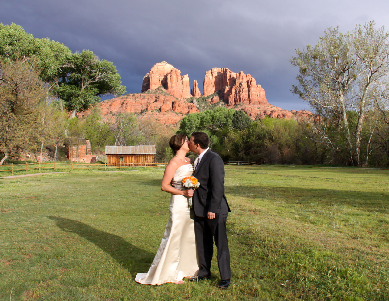 A newly wed couple and their first kiss after being married in front of Cathedral Rock in Sedona, Arizona