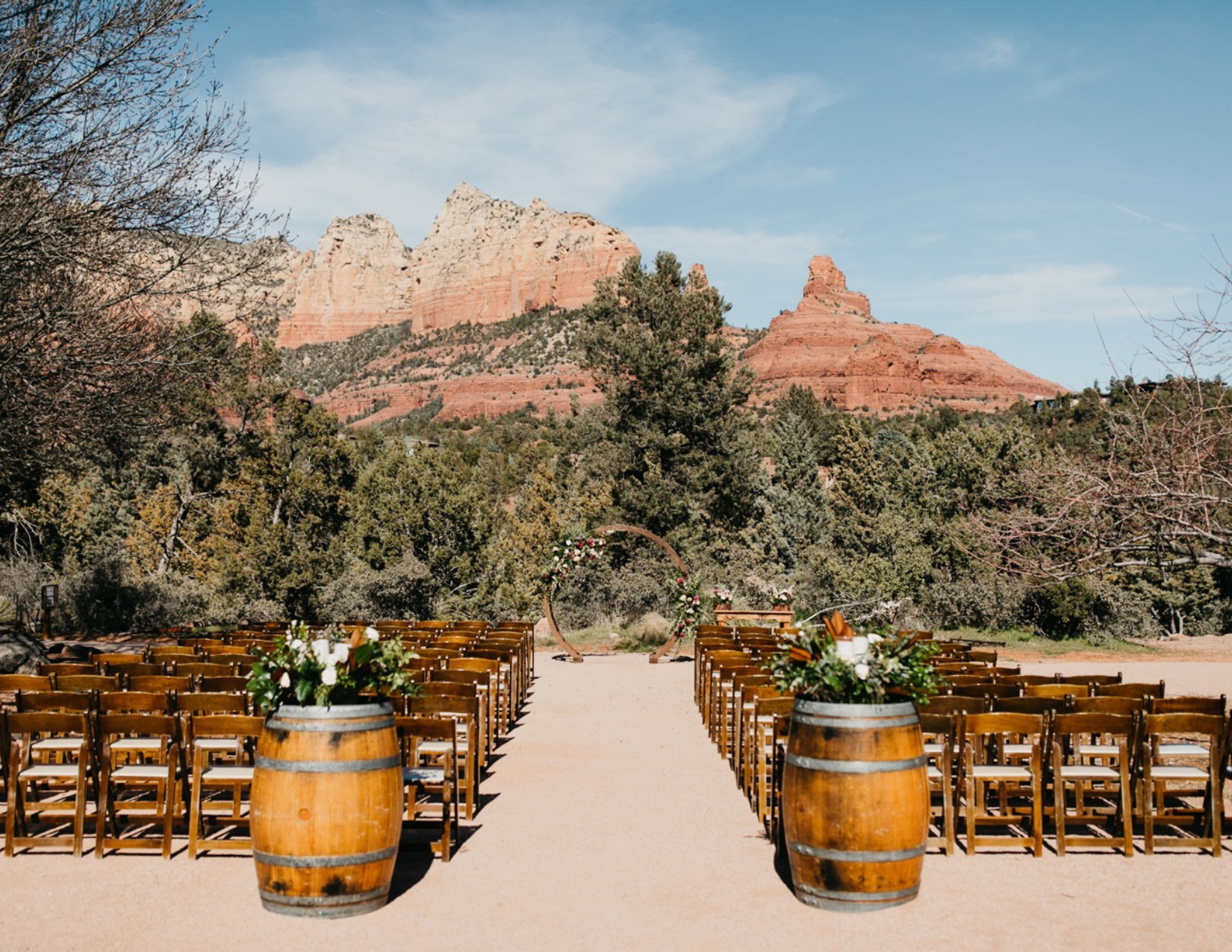 A romantic wedding ceremony with Sedona's beautiful red rocks and mountains in the background.