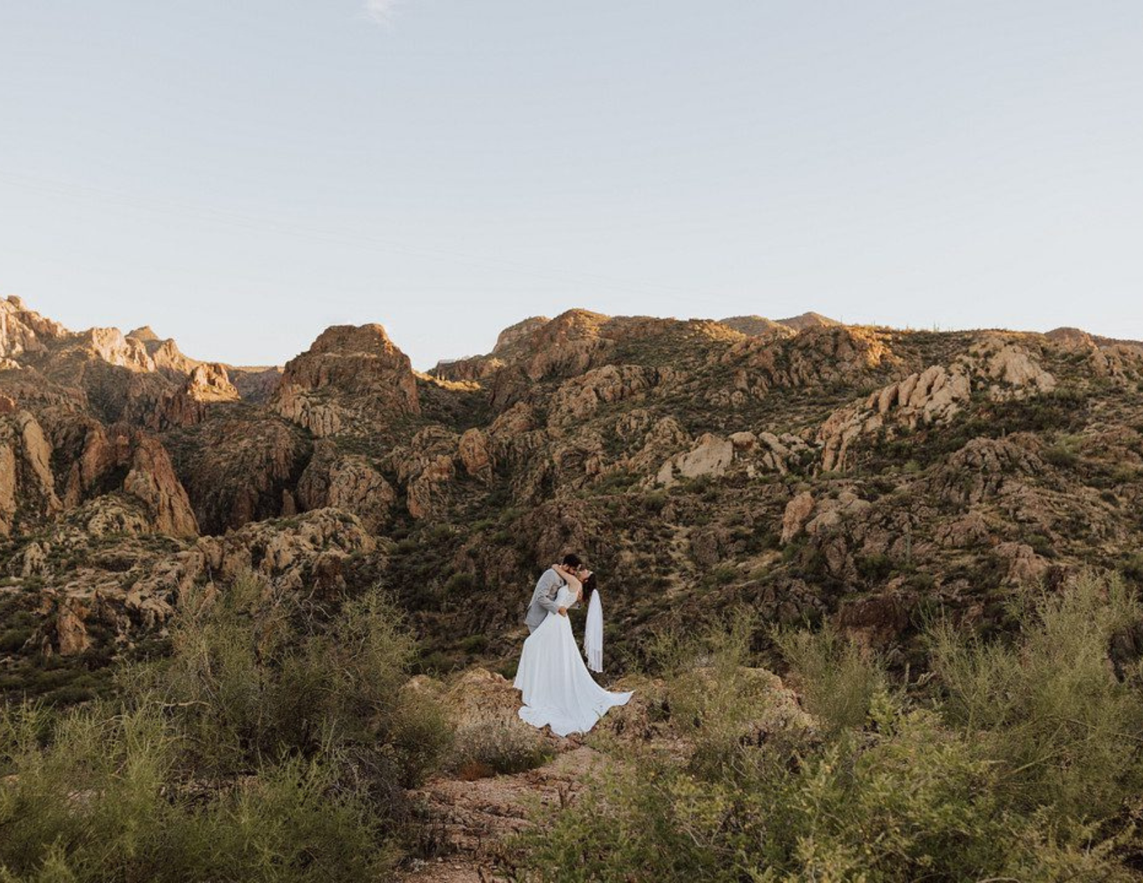 A cute couple sharing their first kiss at an affordable destination wedding in the Tonto National Forest in Arizona