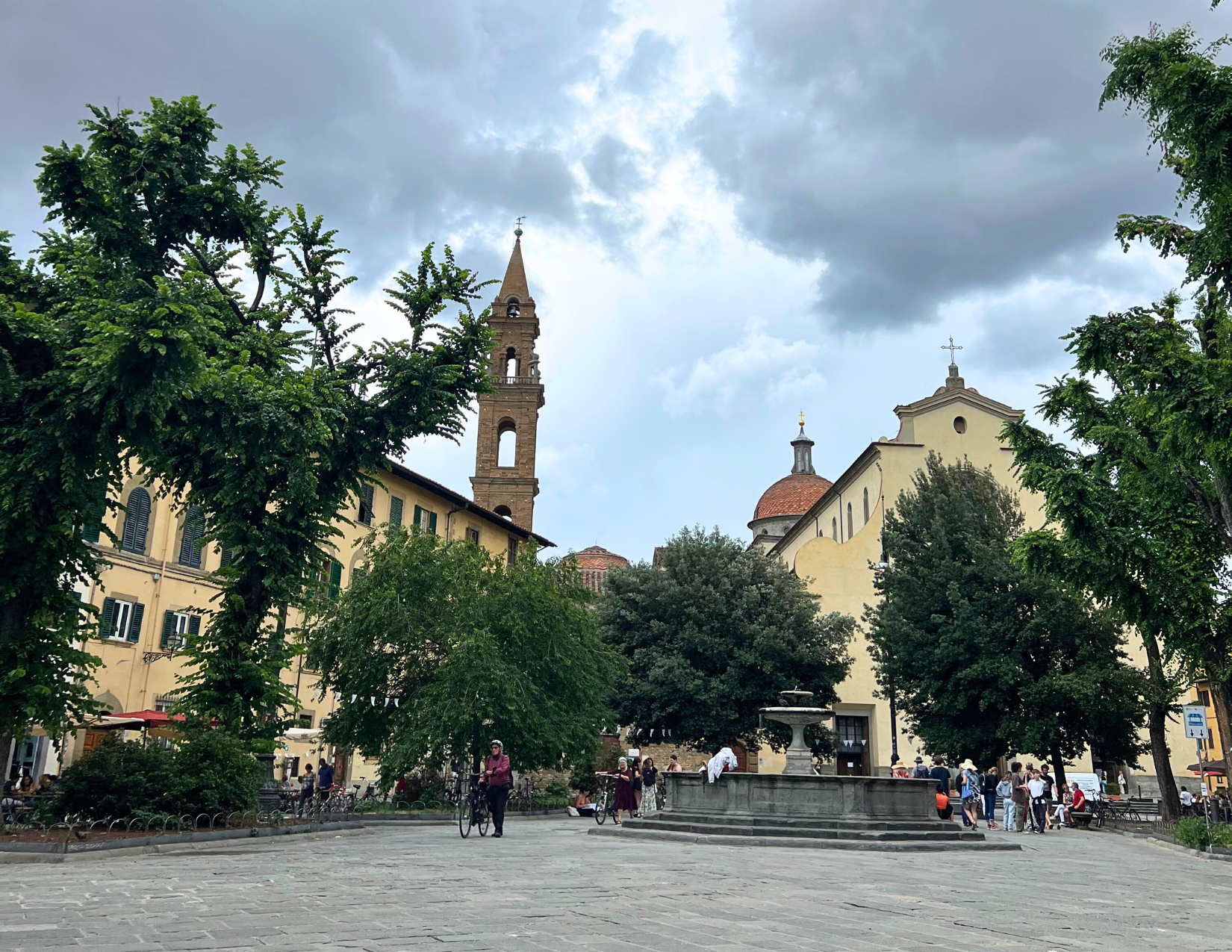 Public fountain surrounded by trees at the Piazzo Santo Spirito in Florence, Italy