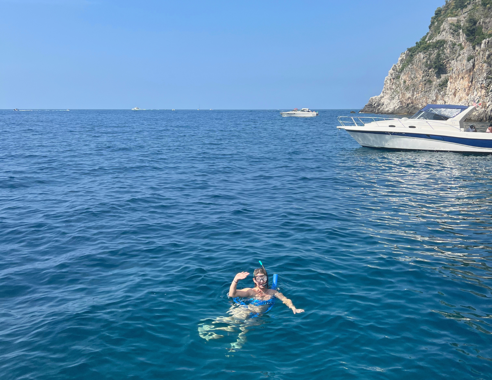 A woman snorkeling in the Tyrrhenian / Mediterranean Sea while on her honeymoon in the Amalfi Coast