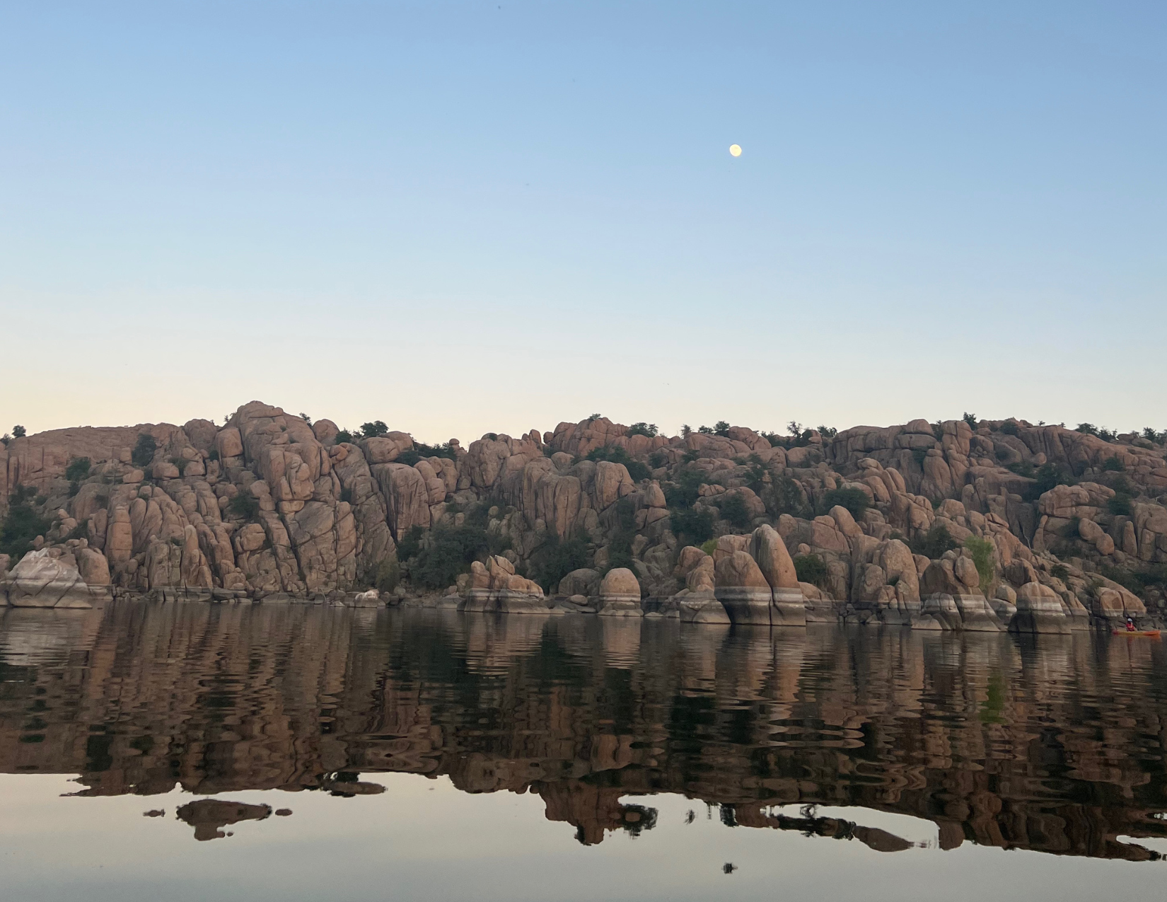 Incredible view of water reflecting the granite boulders on Watson Lake in Prescott, Arizona during a full moon
