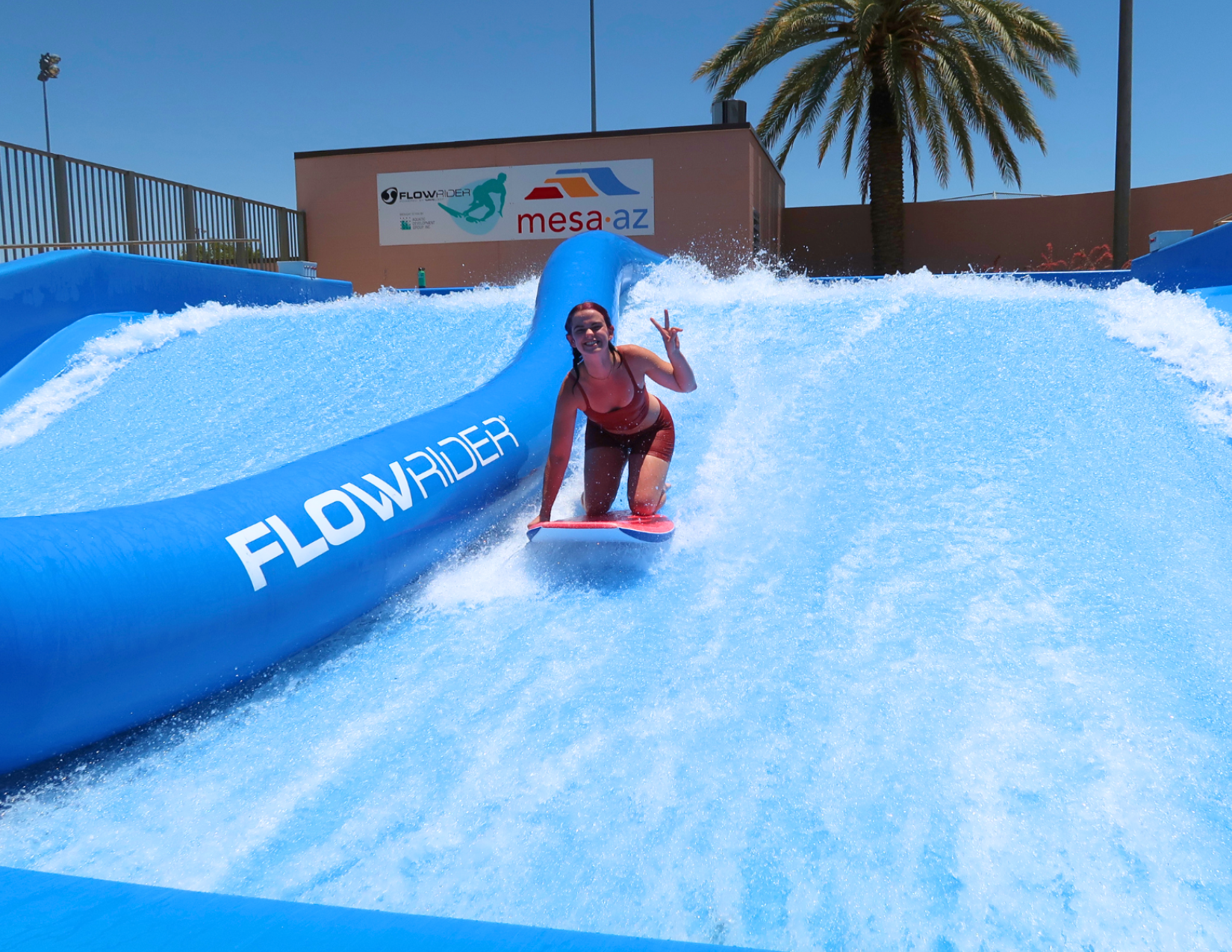 Lacy Cain Baranack surfing on the flowrider, a surfing simulation, in Mesa, Arizona