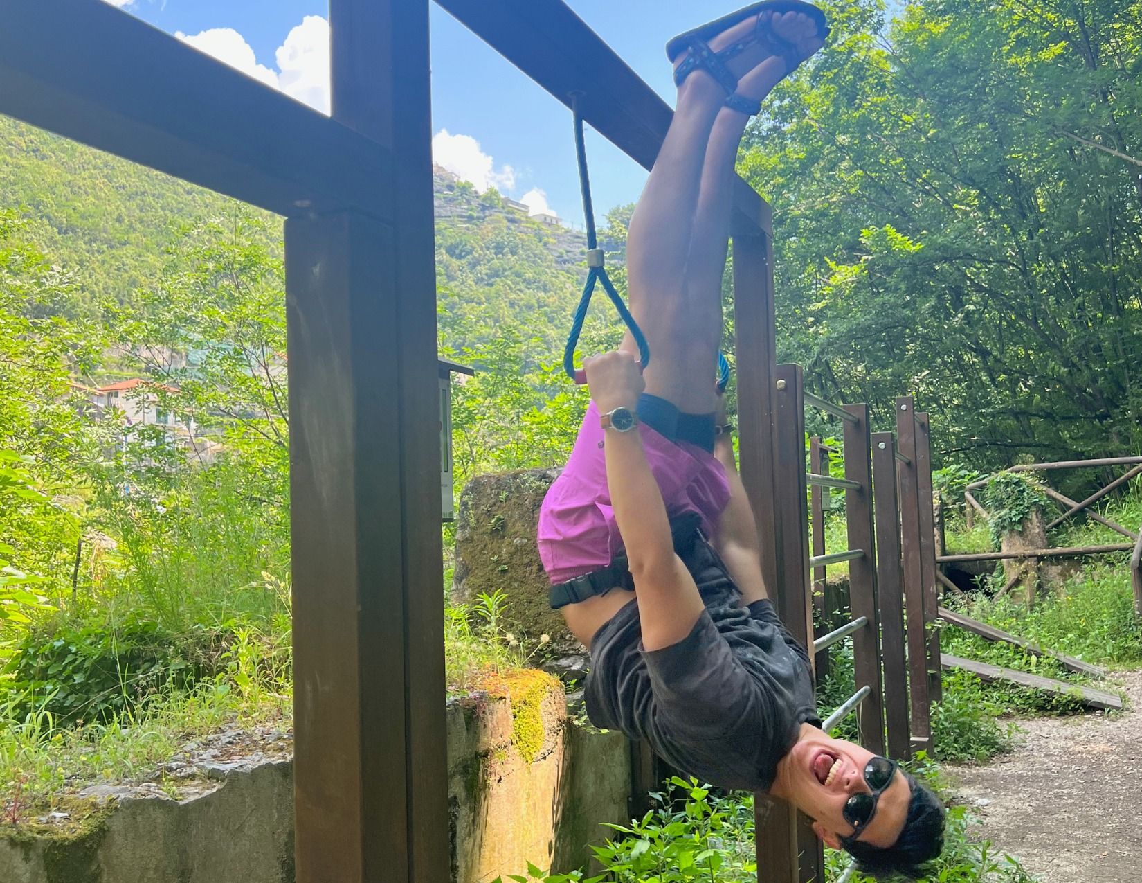 Man hanging upside down on gym equipment on La Selva walk in Amalfi Italy