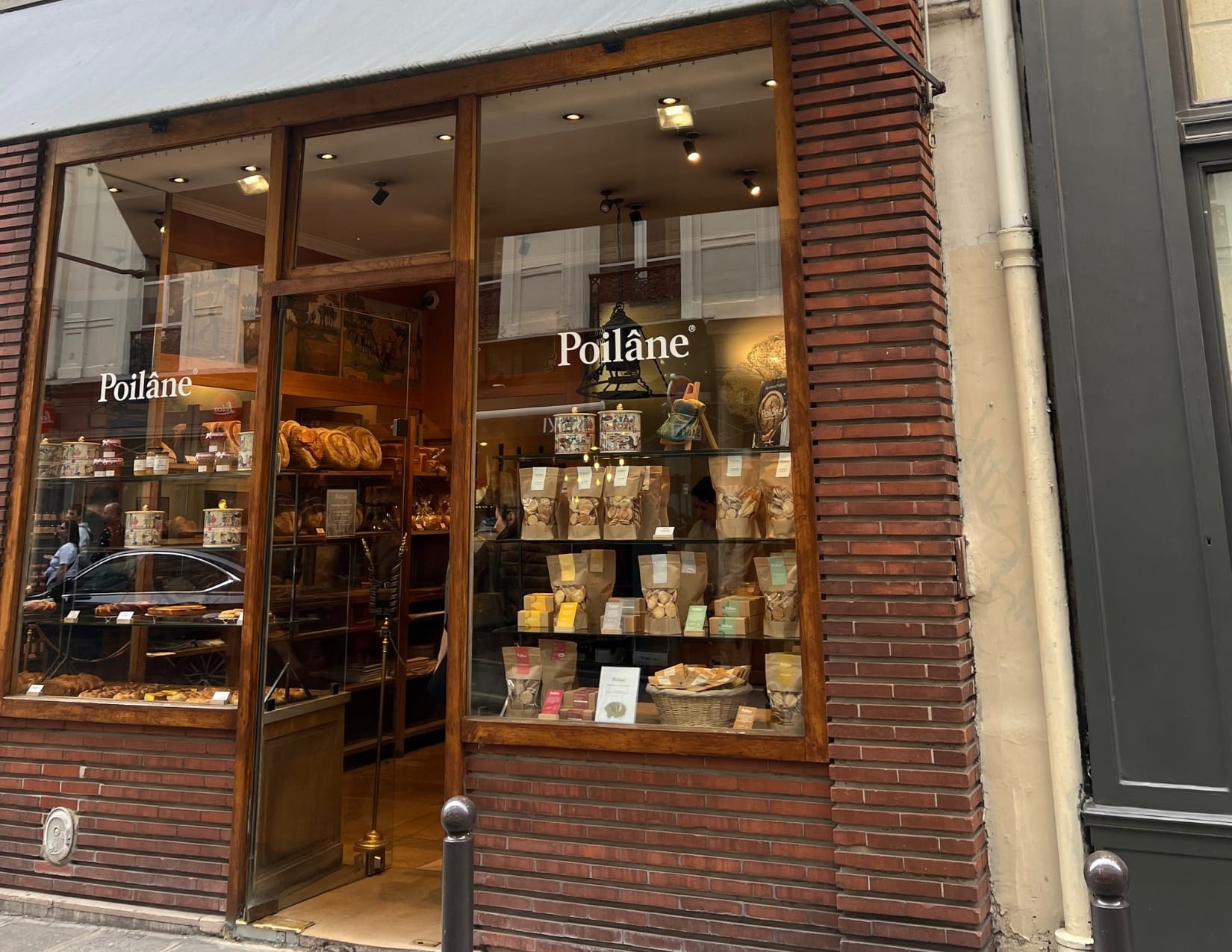 Bags of cookies in the window looking from outside at Poilâne in Paris, France