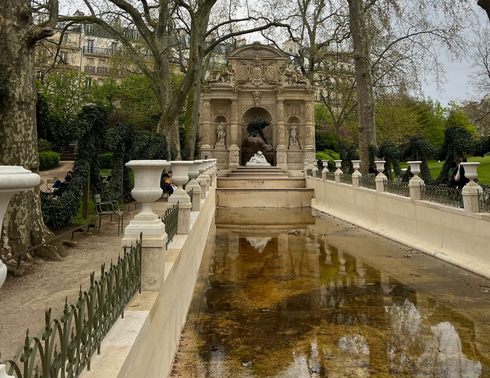 Beautiful stone structure with water at the Jardin du Luxembourg in Paris, France