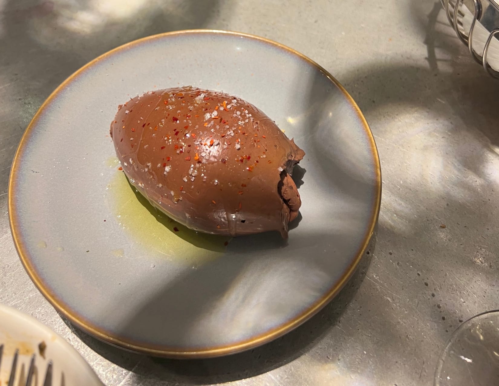 White plate with Quenelle chocolate mousse on it at L'avant Comptoir de la Terre in Paris, France