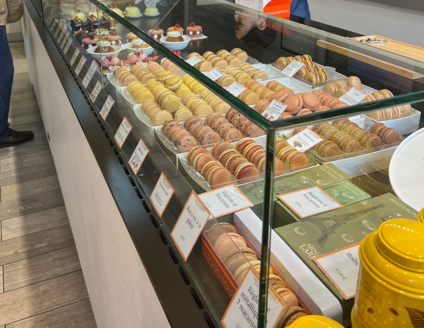 Macaron desserts in a glass case at Arnaud Larher in Paris, France