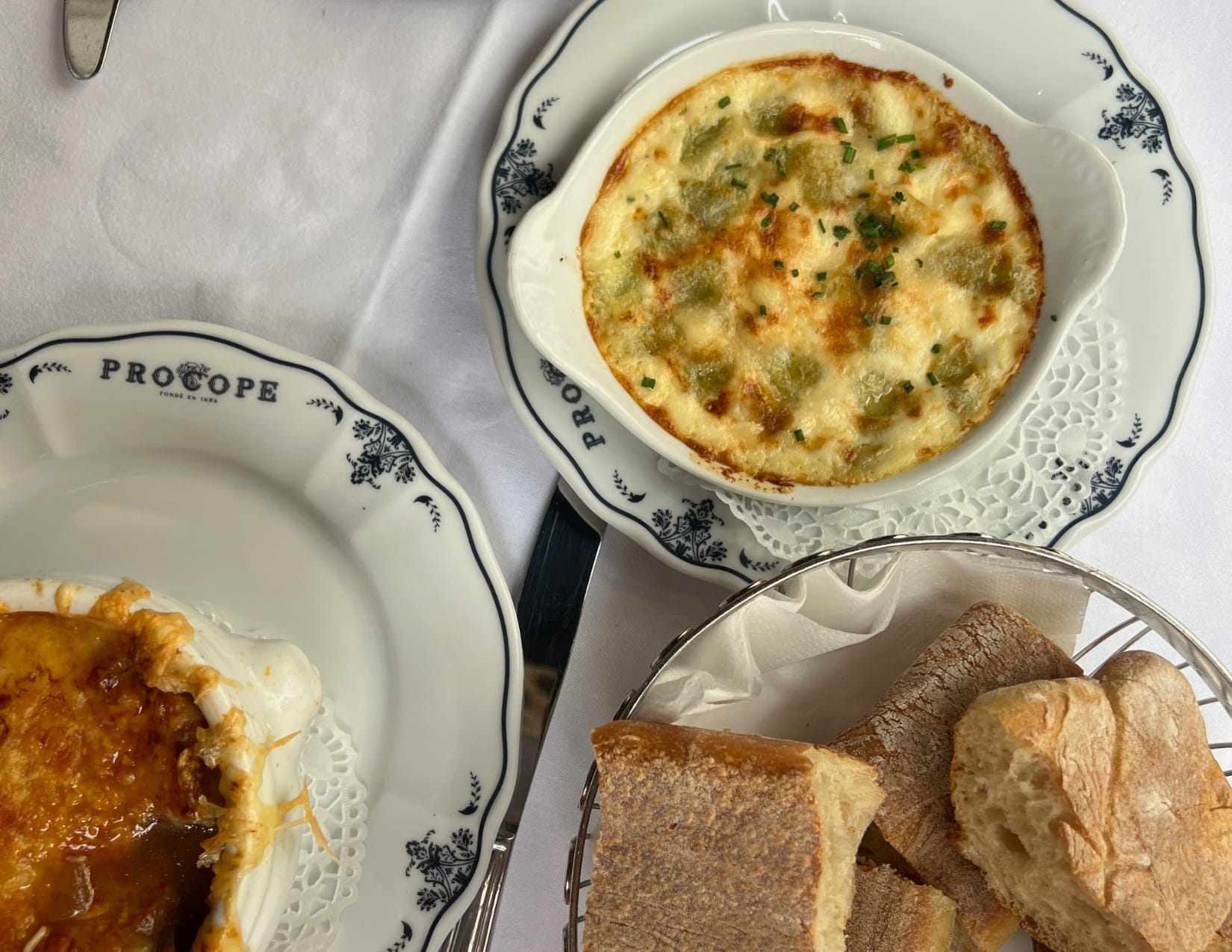 A bowl of French onion soup, ravioli and French bread from Café Procope in Paris, France