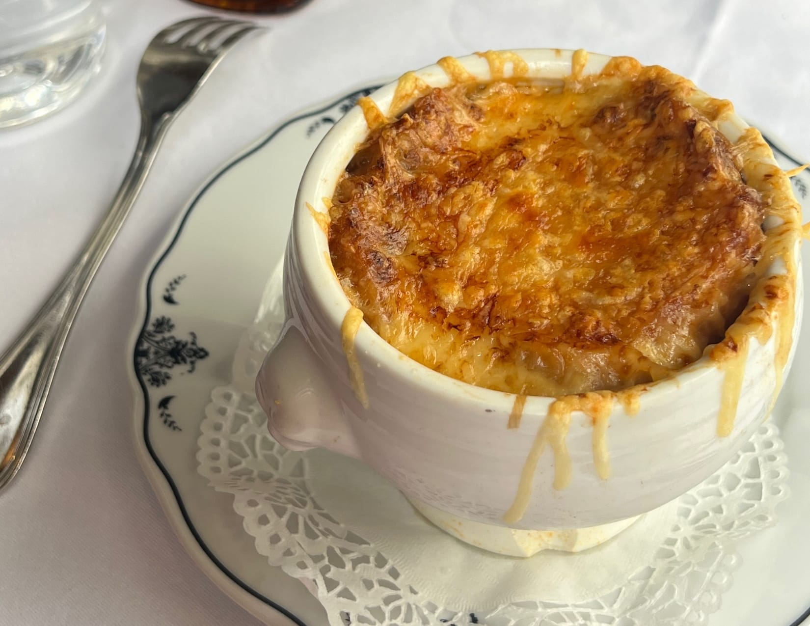 close up bowl of French onion soup from Café Procope in Paris, France