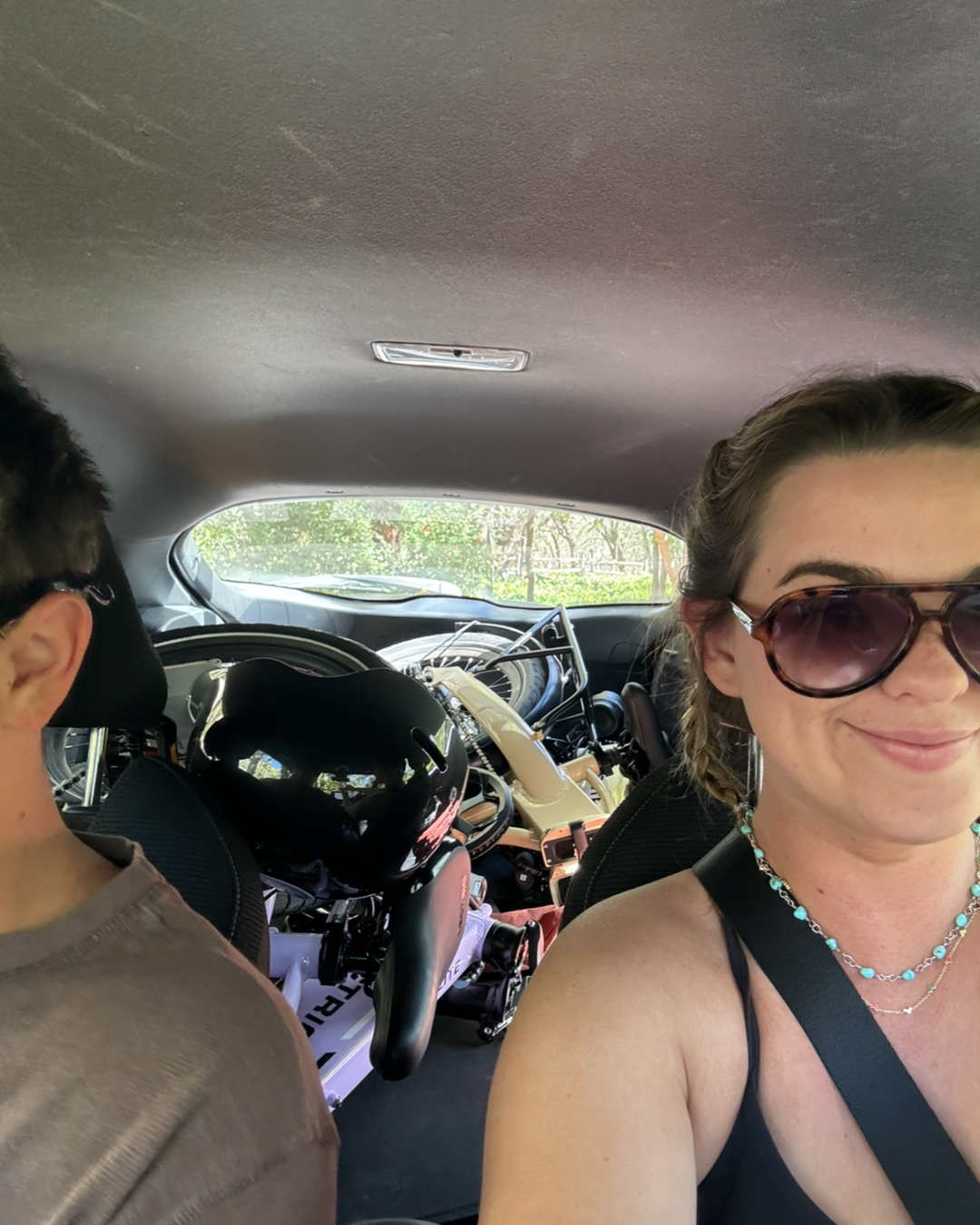 Girl in car with bikes folded in the back seat