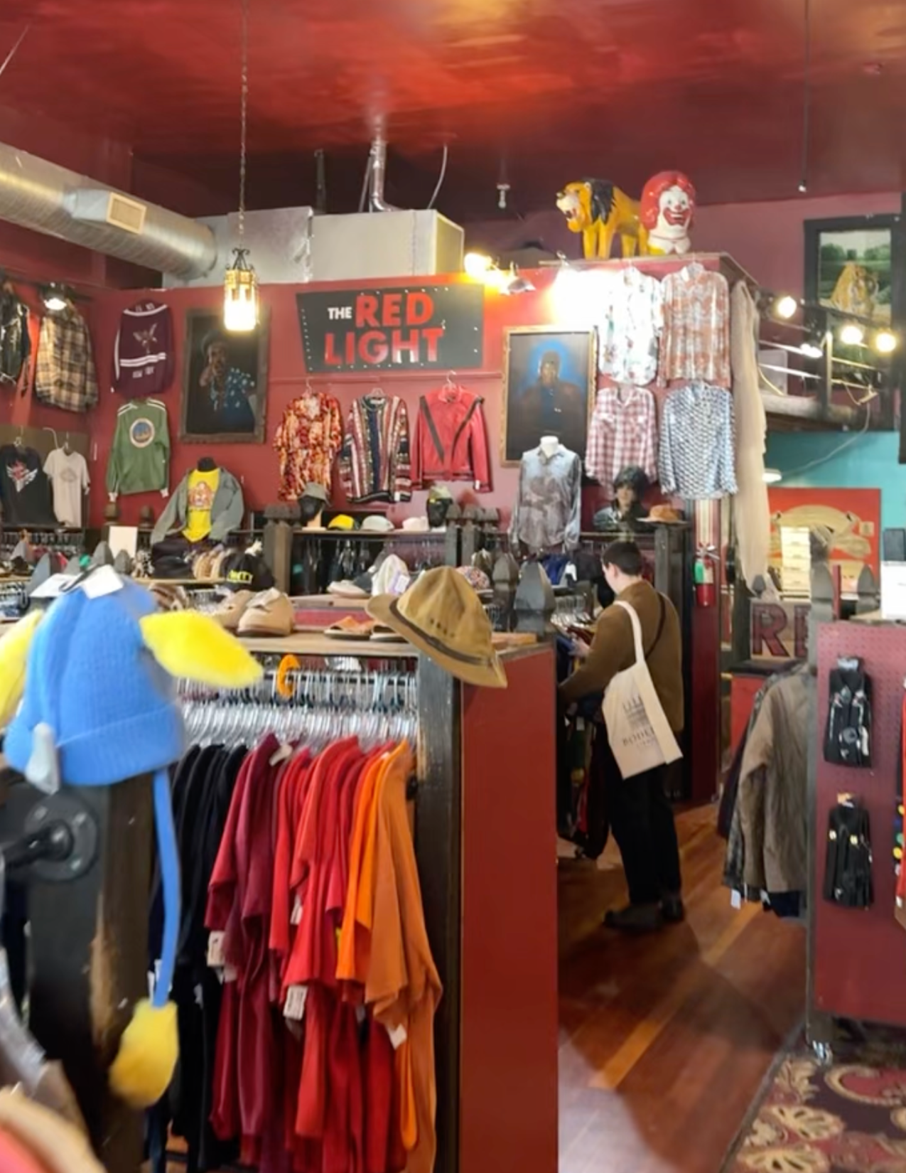 Someone looking thru shirts at The Red Light Clothing Exchange in Portland Oregon
