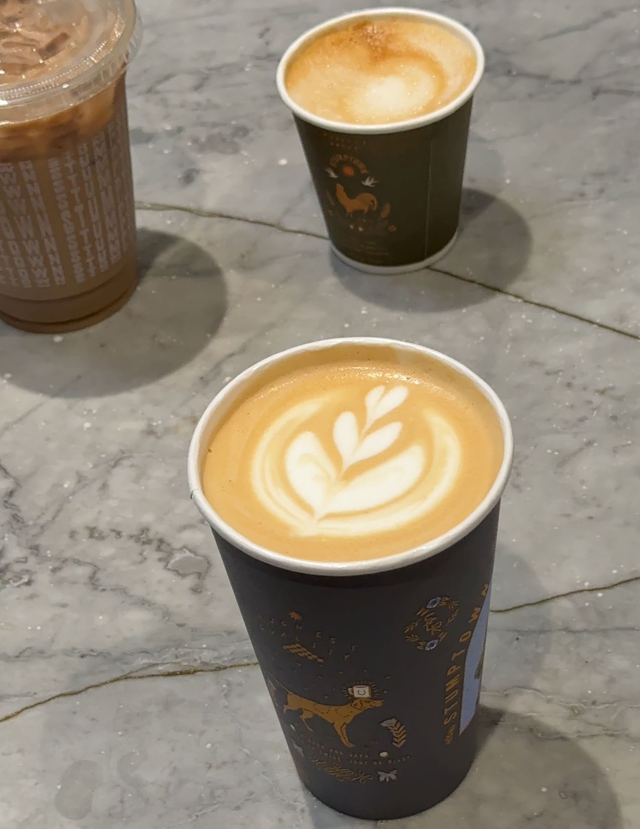 Two cups of coffee with latte art at on a grey counter at Stumptown Coffee in Portland, Oregon