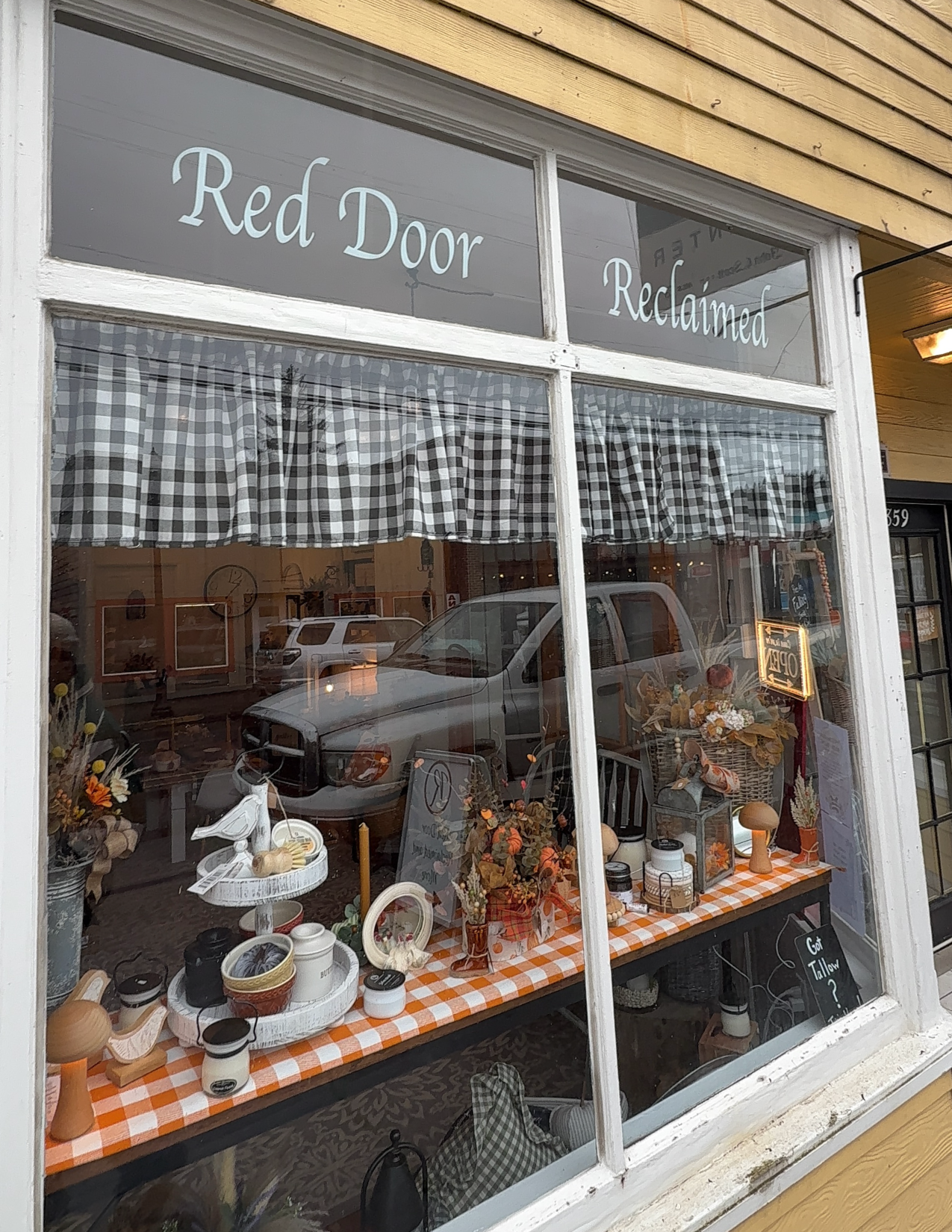 Outdoor view of Red Door Reclaimed store with candles and decorations in the window in Vernonia, Oregon